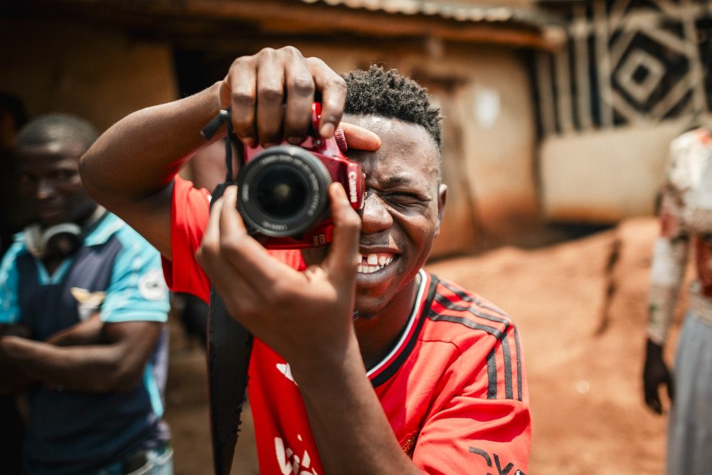A man poses with a camera.