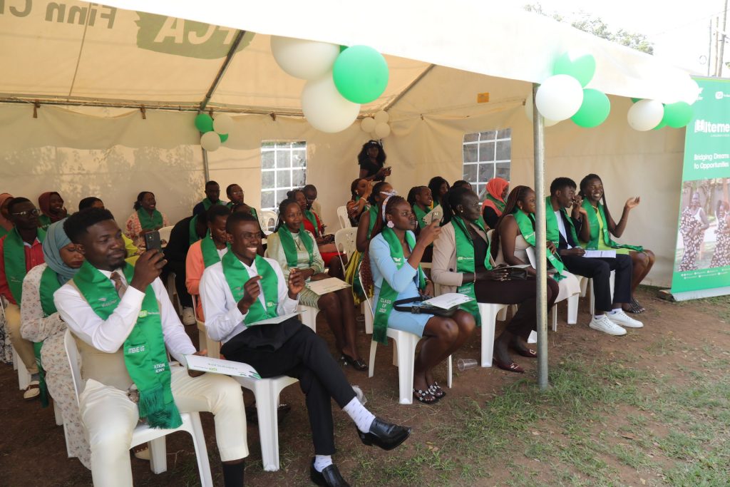 Individuals seated under a tent.