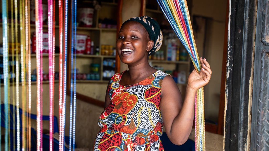 A woman smiling standing infront of a salon