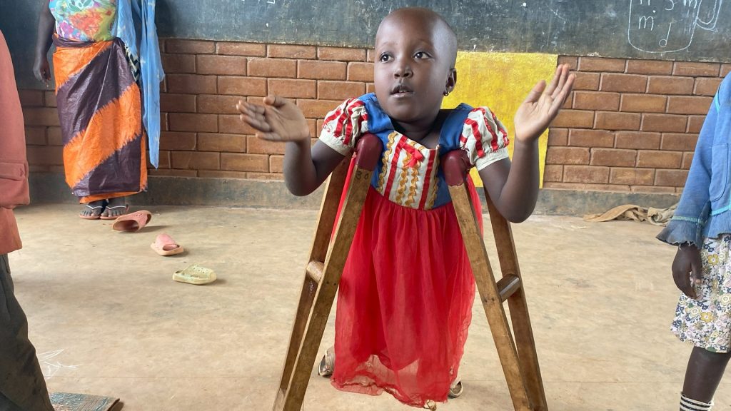 A girl standing with the support of two crutches under her arms